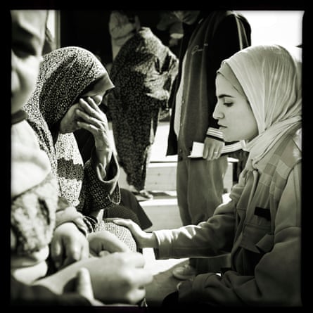 Dr Sara al-Saqqa comforts a woman
