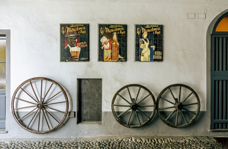 Old cart wheels propped against a wall in the Menabrea brewery