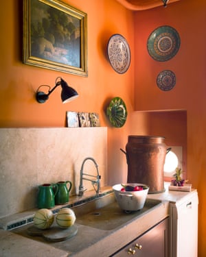 ‘I like to be cosy. Orange just worked’: the kitchen, with traditional sink, and ceramics from Turkey and Morocco.