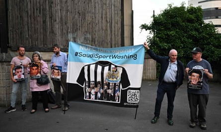 Protesters hold pictures of Saudi detainees during a demonstration against sportwashing ahead of the international friendly football match between Saudi Arabia and Costa Rica at St James’ Park in Newcastle.