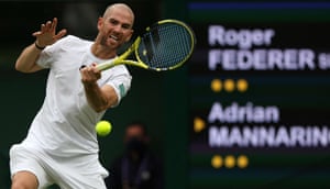Adrian Mannarino returns against Roger Federer.