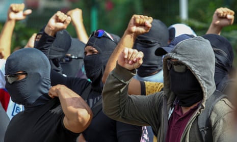Hooded and masked police officers gather during a second day of police strike in Fortaleza, Ceará, in Brazil.