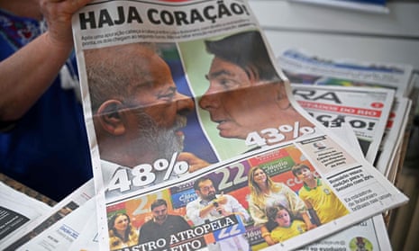 A vendor holds up the front page of one of Brazils National newspapers the day after the Presidential elections in Rio de Janeiro, Brazil on October 3, 2022