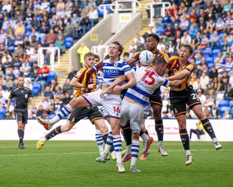 Bradford City and Reading players jump for a header during a match