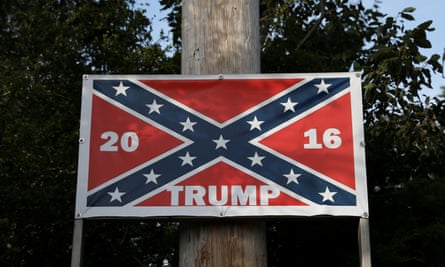 ‘There’s not many white Americans left. They’re a dying breed …’ a confederate flag on a  Trump poster in North Carolina.