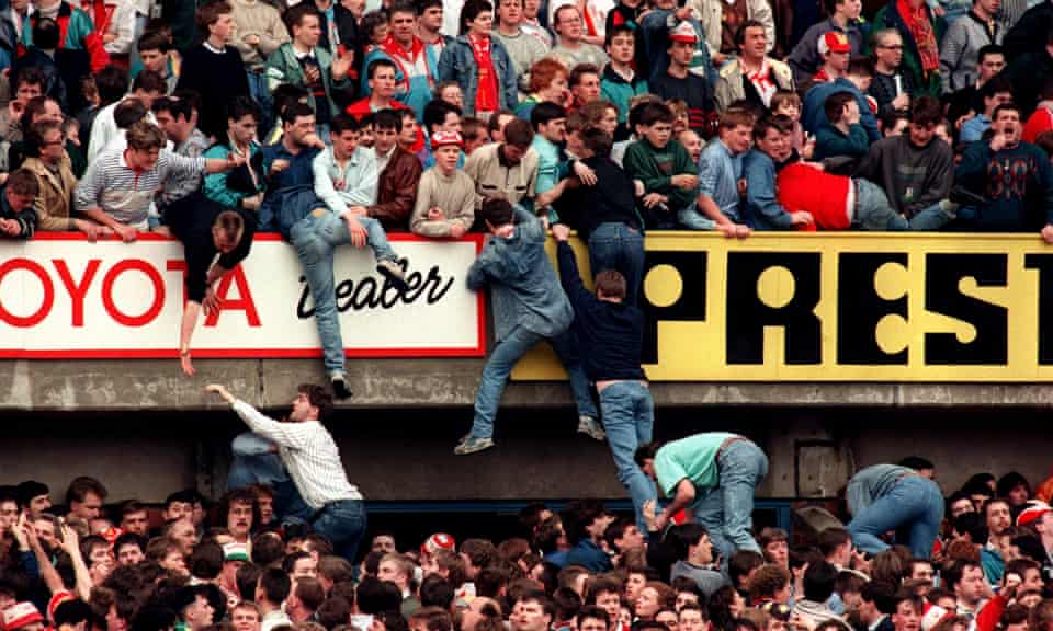 Liverpool supporters try to escape the crush on 15 April 1989.