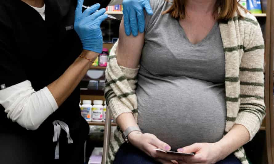 A pregnant women receives a Covid vaccine in Schwenksville, Pennsylvania