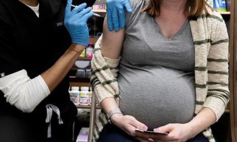 A pregnant women receives a Covid vaccine