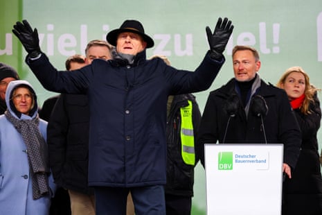 Joachim Rukwied, president of the German Farmers’ Association (Deutscher Bauernverband DBV) gestures as Free Democratic Party (FDP) leader and German Finance Minister Christian Lindner speaks during the protest of German farmers in Berlin
