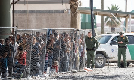 Migrants being held for processing under the Paso del Norte bridge in El Paso, Texas on 27 March.