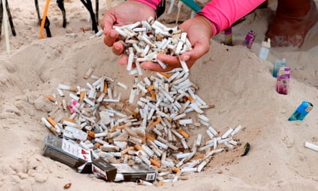 Cigarette filters are gathered by Israeli volunteers taking part in a mass beach clean up during a one-day operation for beach cleaning in October 2020.