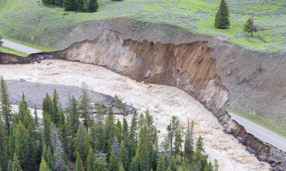 A handout picture on the official Twitter account of Yellowstone national park shows an aerial view of a paved road, eroded and washed out in several places.