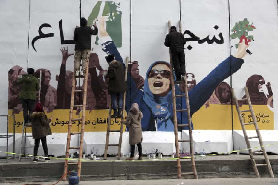 Afghan artists overgarment   a mural connected  a wall