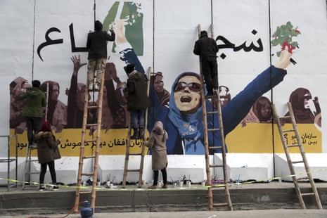 Artists paint a mural on a wall of the Ministry of Women’s Affairs ministry to mark International Women’s Day in Kabul, March 2019.