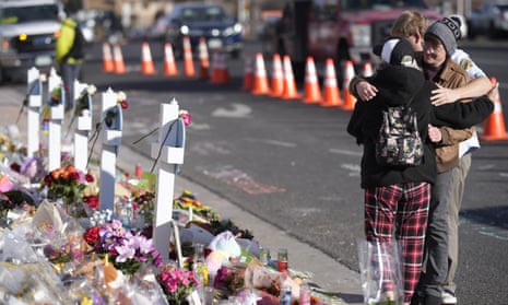 Visitors hug Wednesday at makeshift memorial near the scene of a mass shooting in Colorado Springs, Colorado.