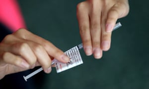 A nurse prepares a Covid vaccine dose at Qudos Bank Arena vaccination clinic in Sydney.
