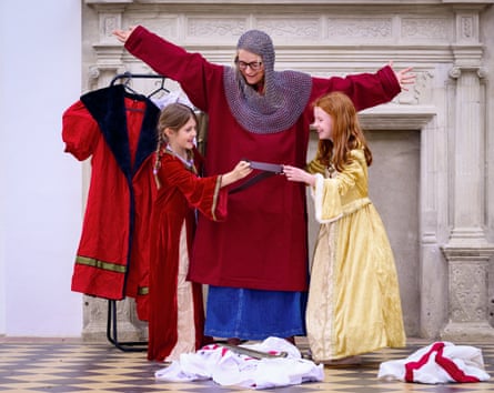 Woman in chainmail with two girls in long dresses