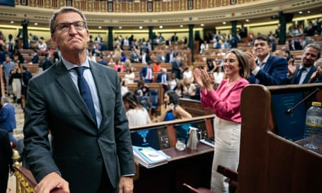 Leader of the People’s Party Alberto Núñez Feijóo (left) receives applause after his speech during the debate that will conclude with a first round of voting on his investiture, at the lower chamber in Madrid, Spain.