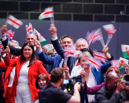 Labour politicians waving flags.