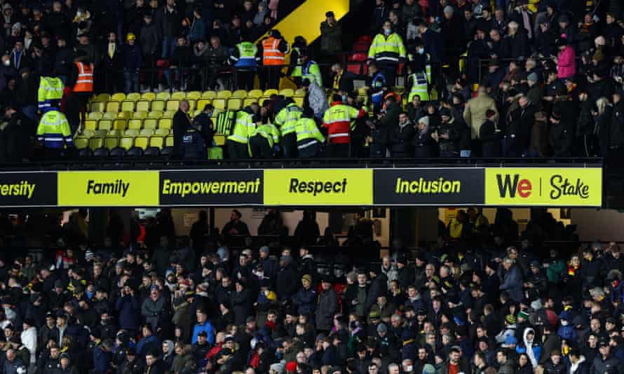 Medical staff rush to help the stricken supporter