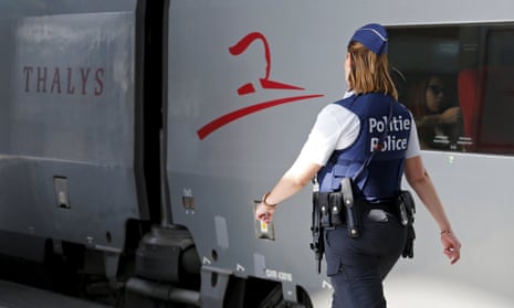 A Belgian police officer patrols at the Thalys train terminal in Brussels, where the gunman boarded the train