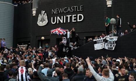 Newcastle United supporters celebrate outside St James' Park
