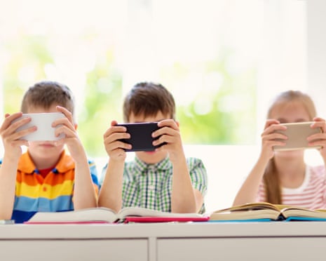 Children sitting in the room with smart phones