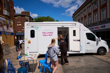 The Living Well Bus parked in Warrington centre with women milling about outside