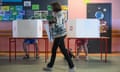 People cast their votes at a polling station during the European parliamentary elections in Warsaw, Poland. 