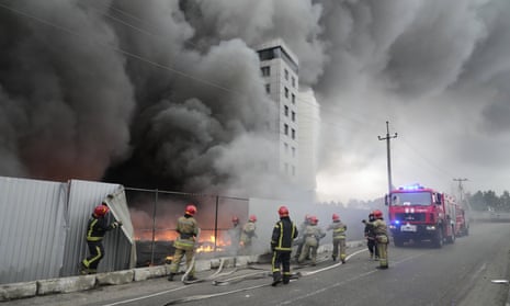 Firefighters work to extinguish a fire at a damaged logistic centre after shelling in Kyiv.