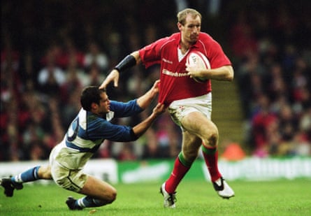 Gareth Thomas takes the ball past Felipe Contepomi of Argentina during a Rugby Union match at the Millennium Stadium, in Cardiff, Wales, in November 2001.