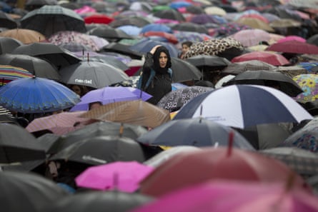 Hundreds of protesters carrying umbrellas take part in a demonstration demanding an end to violence against women in Buenos Aires.