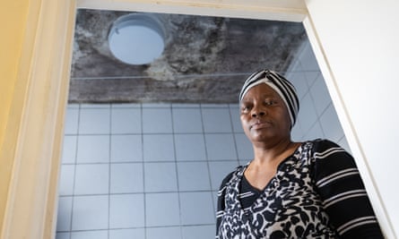 Rosaline Forfornah at the door of her bathroom, covered in damp mould on the ceiling.