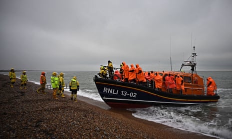 A file photo shows people picked up at sea after attempting to cross the Channel.