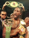 Lennox Lewis displays his championship belts after defeating Evander Holyfield in their November 1999 unification fight.