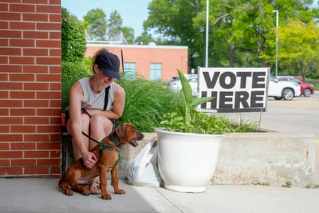 Blaire Massa waits with her dog, Norman, while her husband casts his ballot at a polling location on primary Election Day, Tuesday, June 2, 2026, in Des Moines, Iowa. (AP Photo/Bryon Houlgrave)