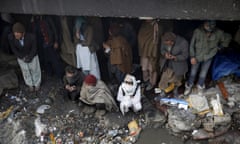 People shelter under the Pul-e Sokhta bridge in western Kabul, during a police round up of suspected drug addicts December 27, 2015. Afghan officials have opened a new drug treatment centre in an abandoned NATO military base in Kabul, in the latest attempt to stamp out the country’s massive problem of drug abuse. Camp Phoenix, a former training camp on the edges of Kabul set up by the U.S. army in 2003, will take in around 1,000 homeless drug addicts who will receive food, medical attention and treatment, said Public Health Minister Ferozuddin Feroz. Picture taken December 27, 2015. REUTERS/Ahmad Masood - GF20000088684