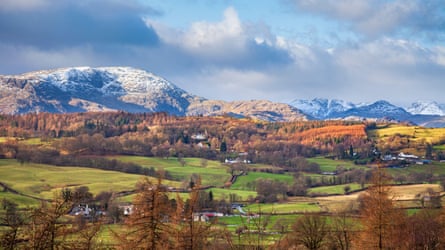 Snowy hills and a green valley
