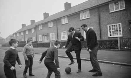 Terry Venables, second right, and Ken Brown playing with local children in 1965 in Dagenham, where they both grew up.