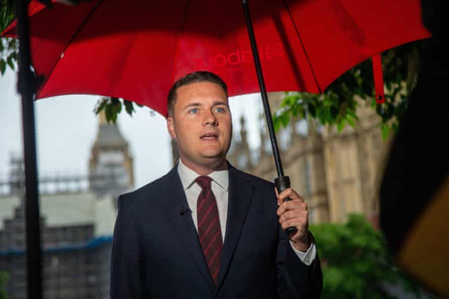 Wes Streeting being interviewed outside parliament in the rain yesterday.