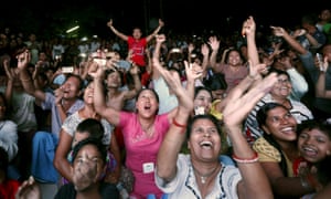Supporters of Aung San Suu Kyi’s National League for Democracy party cheer as they watch the election results on a screen in Mandalay.