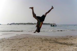 Malick, 30, an acrobat, trains on Ngor beach in Dakar.
