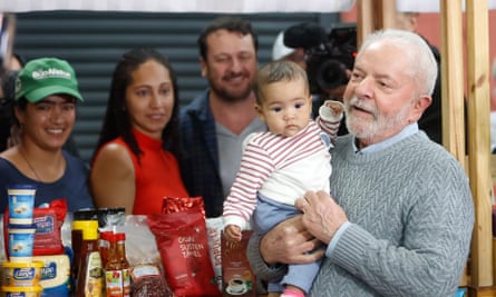 Presidential candidate Luiz Inácio Lula da Silva poses for a photo with a baby during a visit last week to a farmers’ fair in Sao Paulo, Brazil.