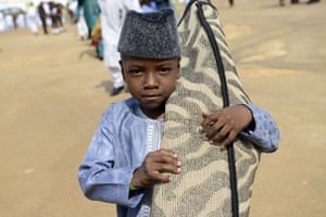 Jos, Nigeria
A young boy arrives with his prayer mat at Isa Kazaure praying ground