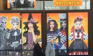 People walk past a Halloween shop in Montreal