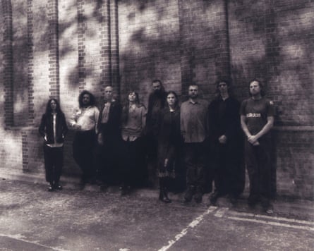 Men and women standing against a wall outside