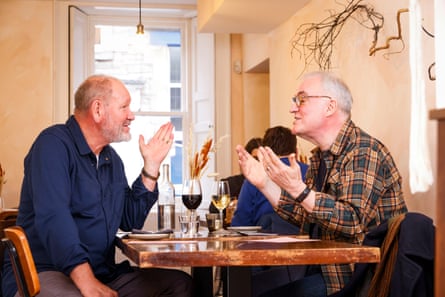 Geoff and Terry chatting at a restaurant table