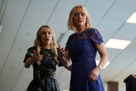 Two white women in dresses look shocked