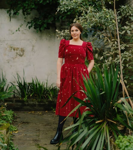 Katy Wix in a wine-red dress in a garden