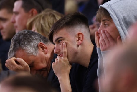 Leicester City fans look dejected during the match against Liverpool.